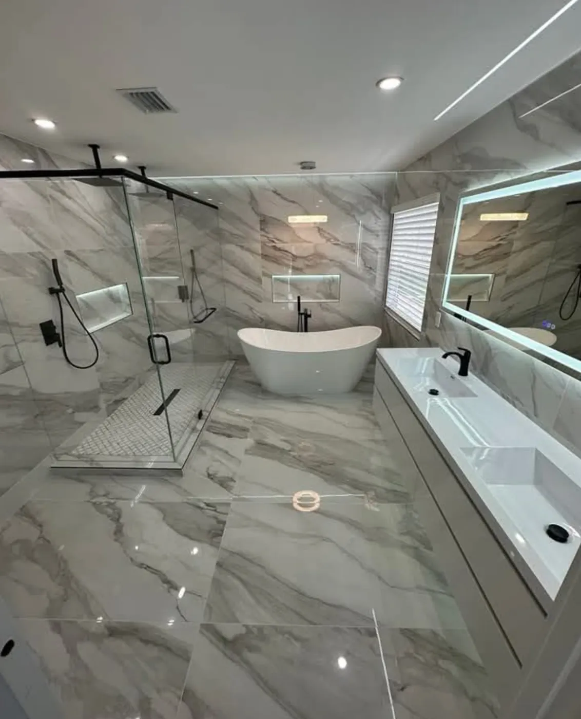 Marble bathroom remodel with a freestanding tub and walk-in shower