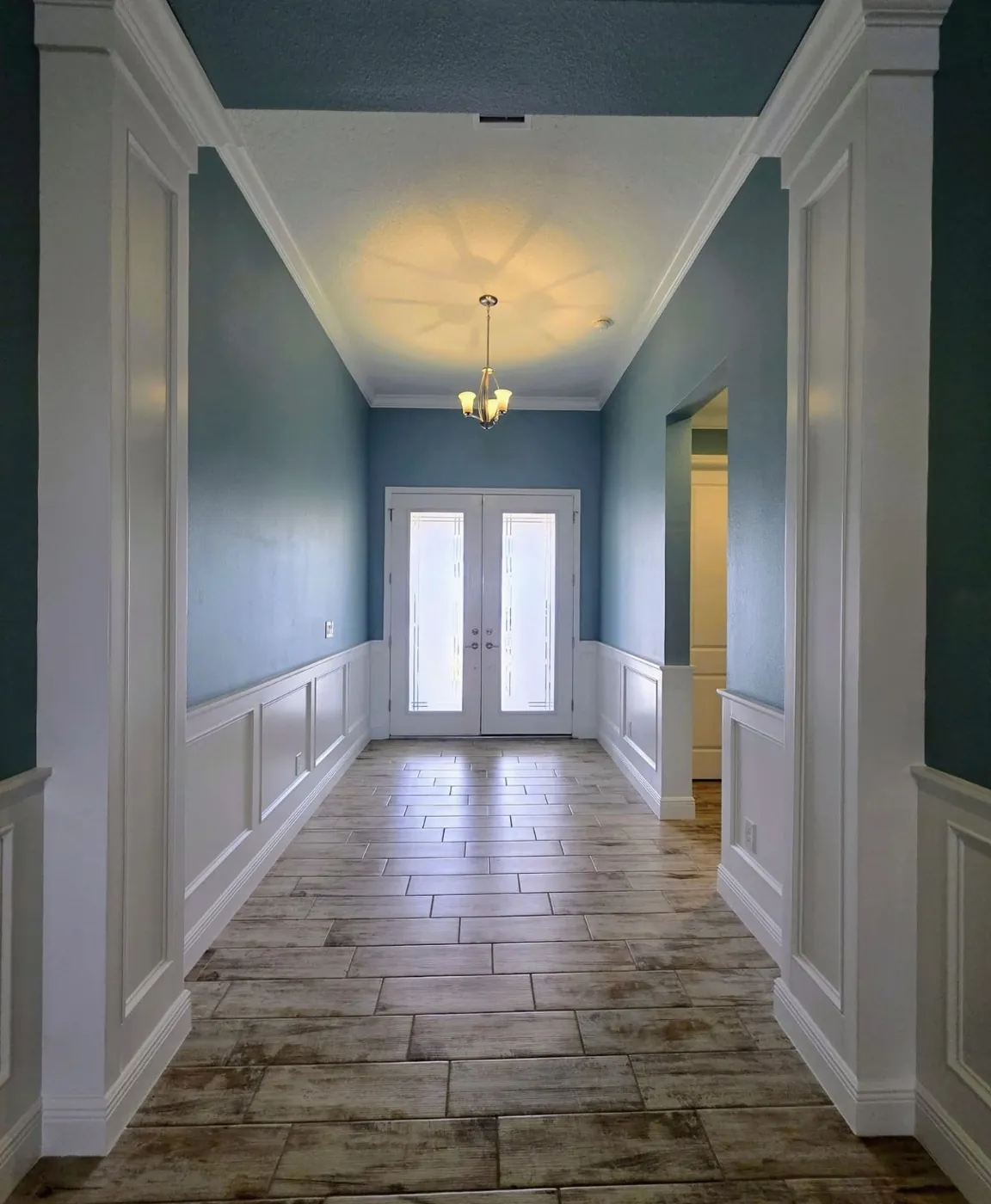 Repainted hallway with wainscoting and fresh trim